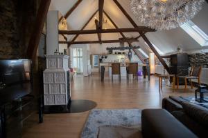a living room with a fireplace and a dining room at Ferienhaus zum Brauneberg in Klotten