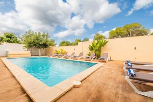 a swimming pool with lounge chairs around it at Villa Beso in San Antonio