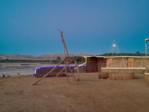 a sculpture in the middle of a desert with a building at Energy camp in Bawati