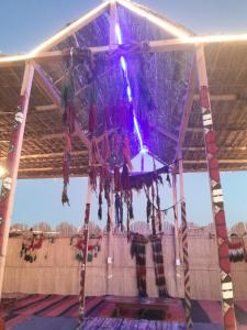 a chandelier hanging from the ceiling of a stage at Energy camp in Bawati +140 photos