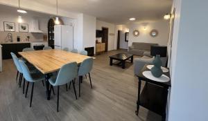 a dining room and living room with a table and chairs at Casa rural Macondo in Trujillanos