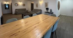 a wooden table and chairs in a living room at Casa rural Macondo in Trujillanos +26 photos
