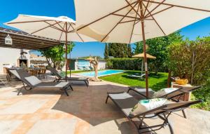 a patio with chairs and umbrellas next to a pool at Es Collet De Manacor in Manacor +54 photos