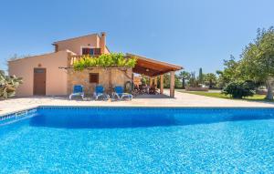 a villa with a swimming pool in front of a house at Can Cremat in Artá