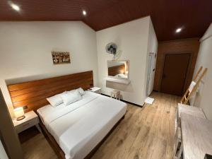 a bedroom with a large white bed and wooden floors at Sunsei Beach Negombo in Negombo +57 photos