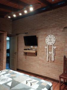 a room with a brick wall with a clock on it at soy ahora segunda in San Javier
