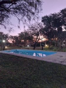 a swimming pool in a park at night at soy ahora segunda in San Javier