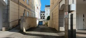 an alley between two buildings in a city at Manisa I in Ribadeo