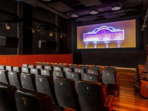 an auditorium with chairs and a screen with a movie at Pousada Vila do Mar in Búzios +87 photos