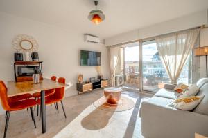 a living room with a table and a couch at Studio vue Mer Alegria in Sainte-Maxime