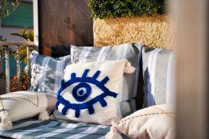 a blue and white pillow on a chair with pillows at Studio vue Mer Alegria in Sainte-Maxime