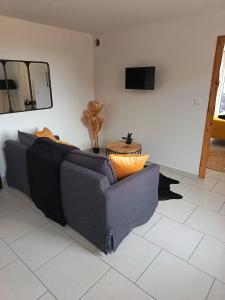 a living room with a couch and a table at Gites de Lenny in Valréas