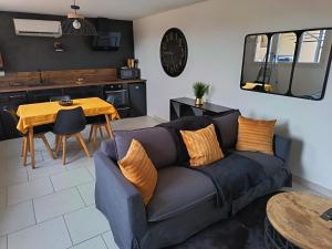 a living room with a couch and a table at Gites de Lenny in Valréas