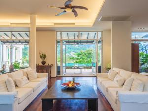 a living room with white couches and a table at Katamanda - Villa Amanzi in Kata Beach