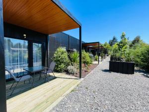 a house with a wooden deck with a table and chairs at Hotel Boutique 501 in Los Ángeles