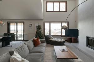 a living room with a couch and a table at Lake view - Ski In-Out in Mont-Tremblant