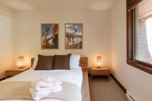 a bedroom with two beds with towels on them at Lake view - Ski In-Out in Mont-Tremblant