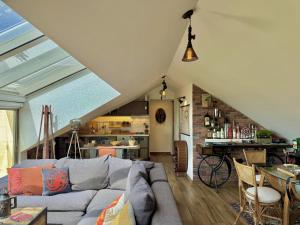 a living room with a couch and a table at Deluxe Loft at Monteverde in Beit Meri