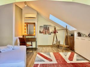 a room with a bed and a desk and a attic at Deluxe Loft at Monteverde in Beit Meri