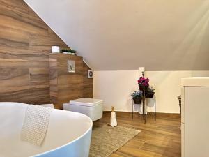 a bathroom with a tub and a toilet in a room at Deluxe Loft at Monteverde in Beit Meri +48 photos