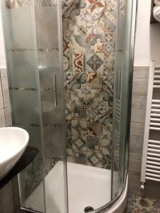 a shower with a glass door next to a sink at Agriturismo Cà da Nonna Rosa in Neirone +15 photos
