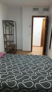 a bedroom with a bed with a black and white carpet at EMMI Guesthouse in Alicante