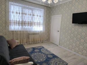 a living room with a couch and a window at Апарт-Отель Rozi in Svalyava