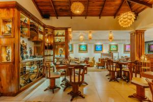 a living room with wooden furniture and a dining room at Hotel & Spa Poco a Poco - Costa Rica in Monteverde Costa Rica
