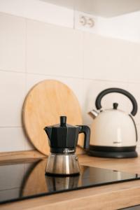 a coffee maker and a tea kettle on a counter at Downtown flat historic Reggio in Reggio di Calabria