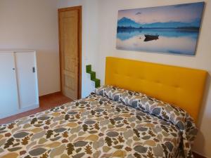 a bedroom with a bed and a painting on the wall at Casa Tia Nieves in Ruiloba