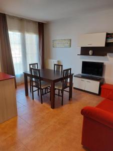 a living room with a dining room table and chairs at Casa Tia Nieves in Ruiloba