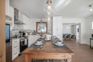 a large kitchen with a wooden table in it at Spacious Boho Retreat Heated Pool-HotTub-Huge Yard in Tampa