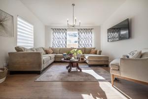 a living room with a couch and a table at Spacious Boho Retreat Heated Pool-HotTub-Huge Yard in Tampa