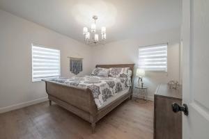 a bedroom with a bed and two windows at Spacious Boho Retreat Heated Pool-HotTub-Huge Yard in Tampa +43 photos