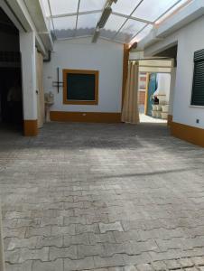 a large room with a projection screen on the wall at Condomínio Equestre in Golegã