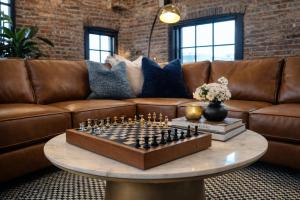 a chess board on a table in a living room at Brick & Bed Riverfront Lofts, T 401 in Saint Louis