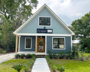 a blue house with a sign on the front of it at 427 Broad Street in Georgetown