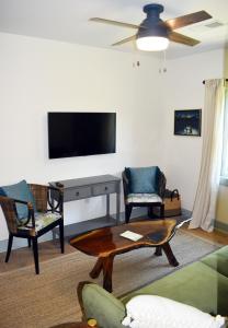 a living room with a tv and a table and chairs at 427 Broad Street in Georgetown