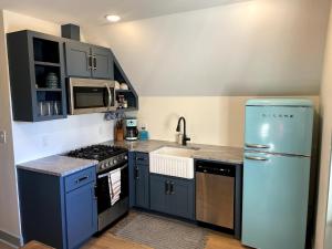 a kitchen with a blue refrigerator and a sink at 427 Broad Street in Georgetown