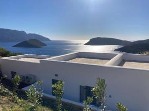 a white house with a view of the ocean at Shaunagh's Place in Kalymnos