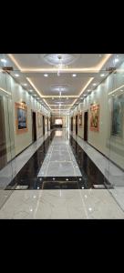 a hallway in a building with paintings on the walls at The KP RESORT in Chīrgaon