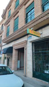 a building with a car parked in front of it at Ático Centro in Socuéllamos