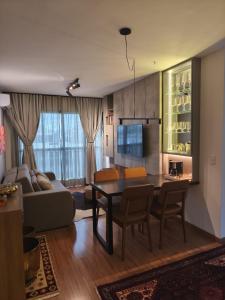 a living room with a table and a couch at Premium Apartment in Bagé in Bagé +8 photos