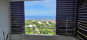 a large window with a view of a city at KAZ Les pêchers in Saint-Denis