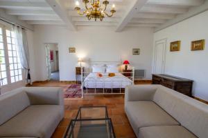 a living room with a bed and two couches at La Gironie in Pomport +35 photos