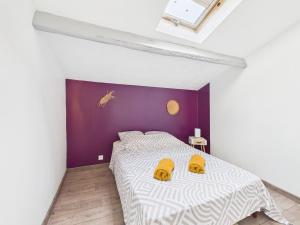 a bedroom with a bed with two yellow slippers at Le Petit Cocon de Ambre in Saint-Paul