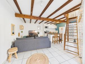 a living room with a couch and a table at Le Petit Cocon de Ambre in Saint-Paul