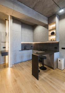 a kitchen with a table and a stool at Designer View Vake in Itʼkhvisi