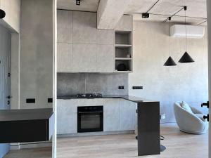 a kitchen with a counter and a stove top oven at Designer View Vake in Itʼkhvisi
