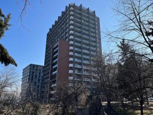 a tall apartment building with trees in front of it at Designer View Vake in Itʼkhvisi